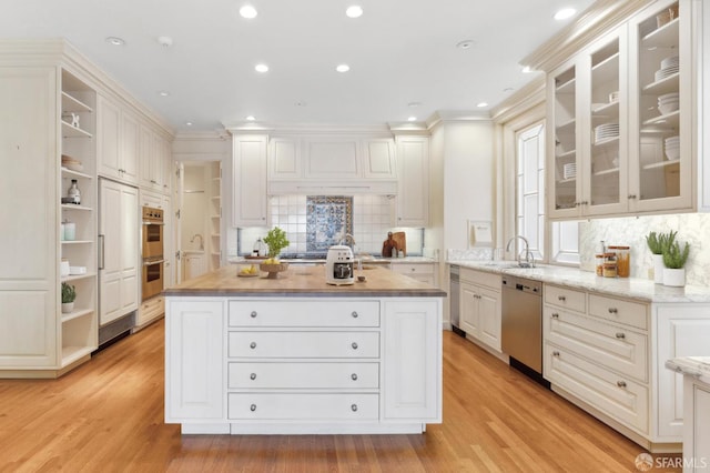2000 Washington St Unit 4, San Francisco, CA 94109 - kitchen featuring open shelves, a sink, a center island, appliances with stainless steel finishes, and light wood-style flooring