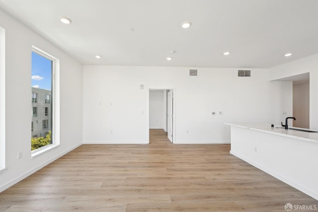 interior space with light hardwood / wood-style floors and sink