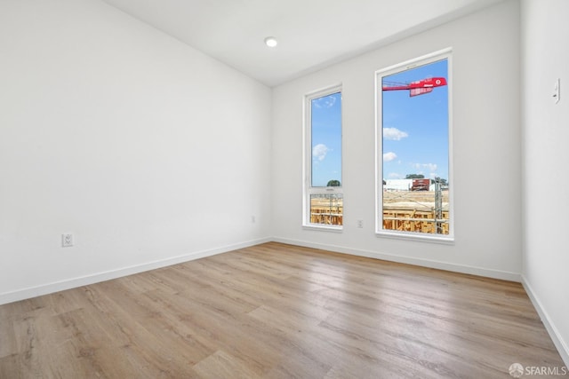 spare room featuring light wood-type flooring