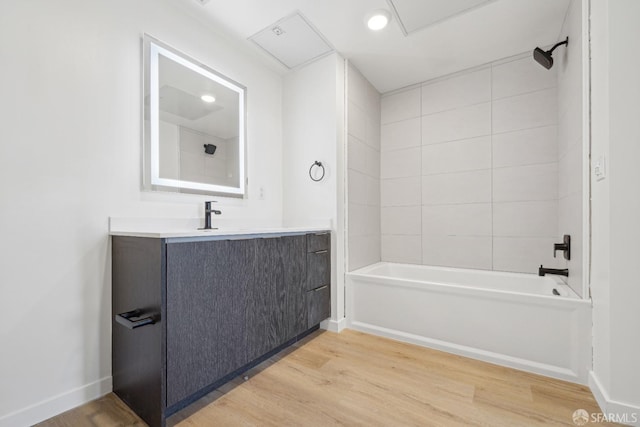 bathroom with vanity, tiled shower / bath combo, and hardwood / wood-style flooring