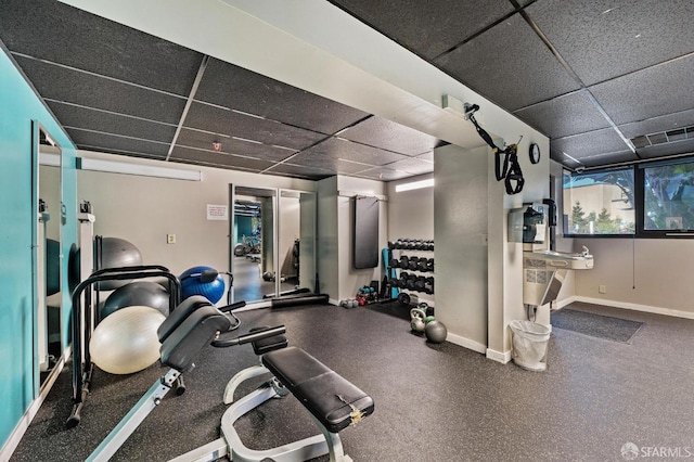 exercise room featuring a paneled ceiling