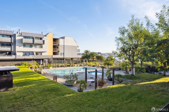 view of pool featuring a yard