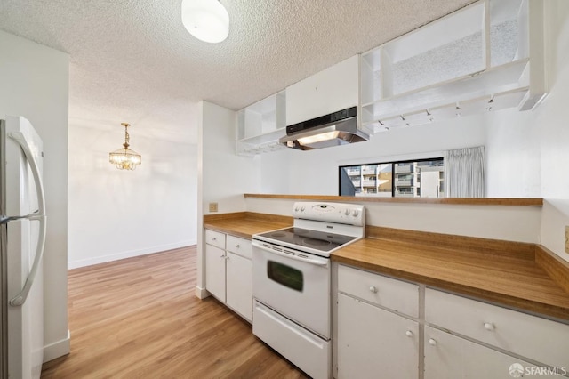 kitchen featuring white appliances, a textured ceiling, hanging light fixtures, butcher block countertops, and white cabinets