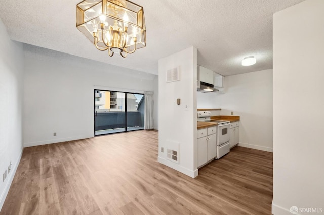 kitchen featuring white cabinetry, a notable chandelier, white electric stove, and light hardwood / wood-style flooring