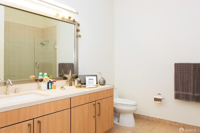 full bath featuring a shower stall, tile patterned flooring, toilet, double vanity, and baseboards