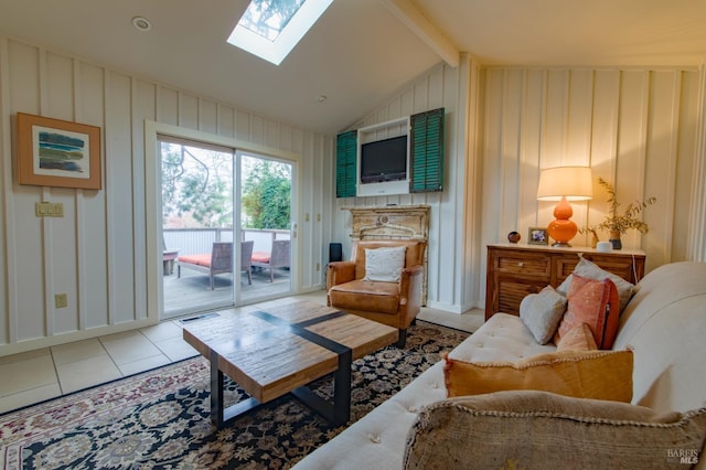 living room featuring vaulted ceiling with skylight and light tile patterned floors