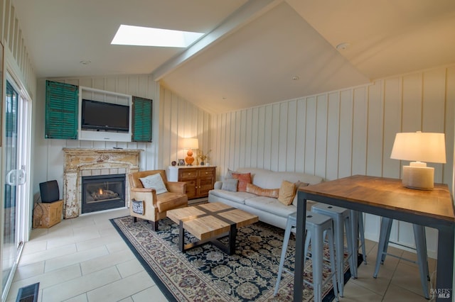 tiled living room with vaulted ceiling with skylight