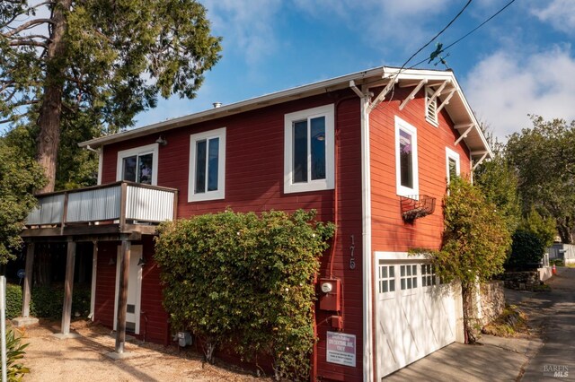 view of front facade with a garage and a wooden deck