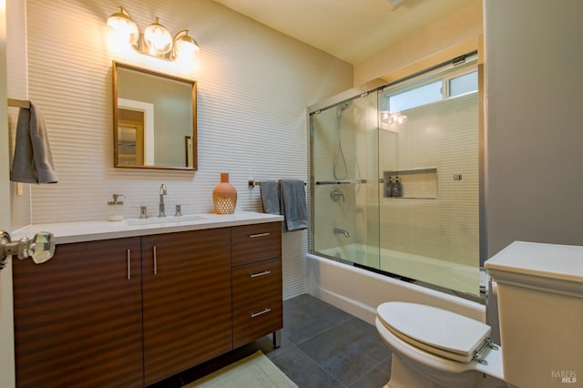 full bathroom featuring tile patterned floors, enclosed tub / shower combo, vanity, and toilet