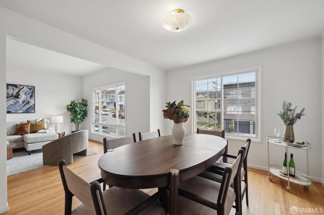 dining area with a wealth of natural light and light hardwood / wood-style floors