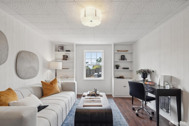 office with dark wood-type flooring and built in shelves