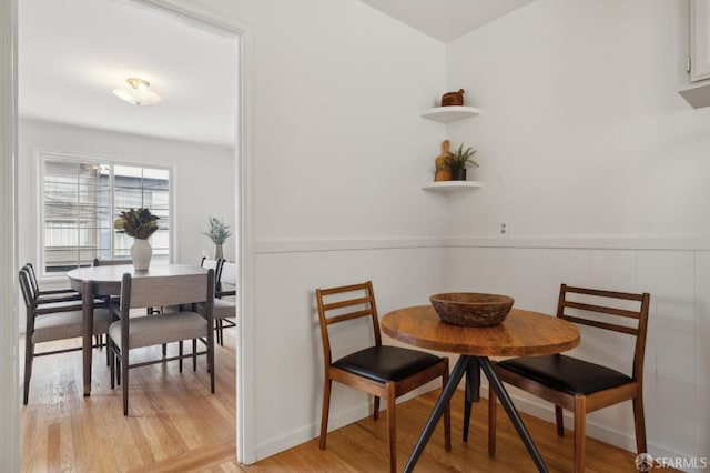 dining space with light hardwood / wood-style floors