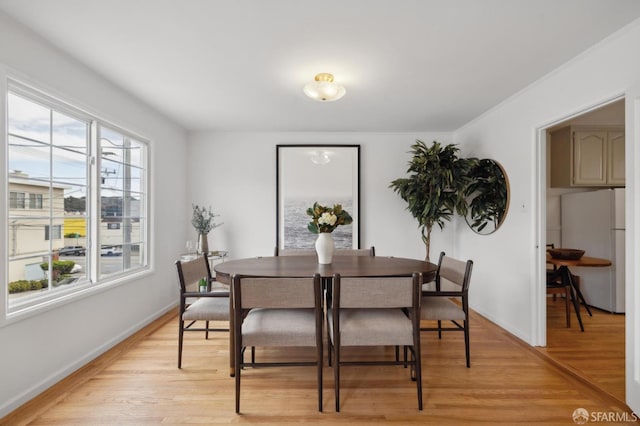 dining space with light hardwood / wood-style floors