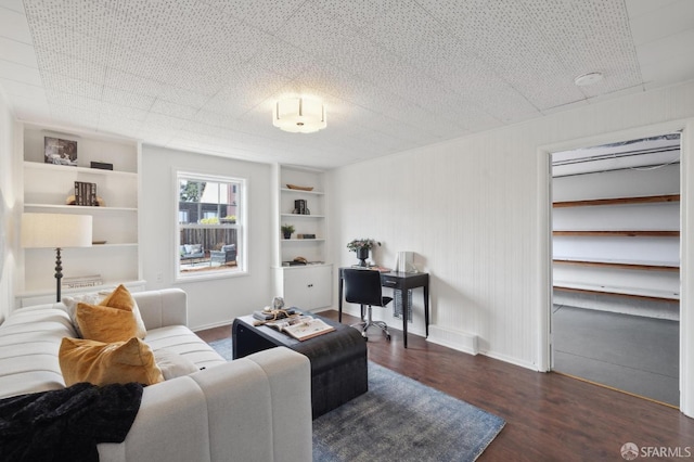 living room featuring dark hardwood / wood-style floors and built in features