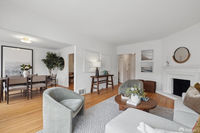 living room with hardwood / wood-style flooring and a fireplace