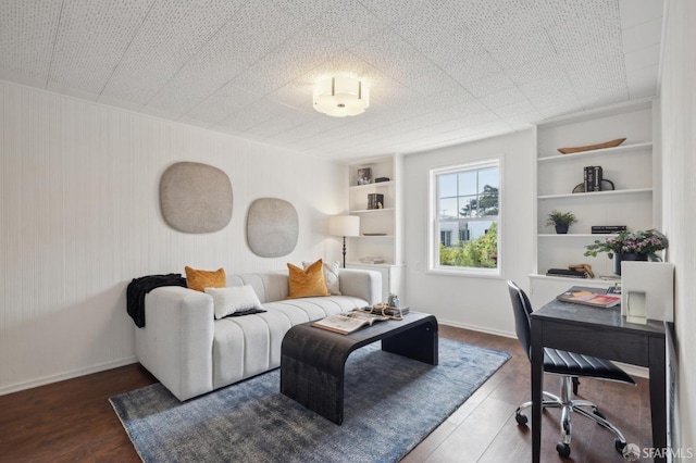 home office with dark hardwood / wood-style floors and built in features