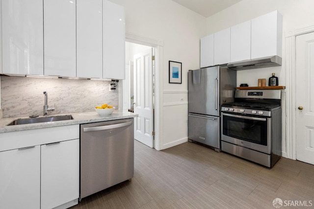 69 Pond St, San Francisco, CA 94114 - kitchen with appliances with stainless steel finishes, range hood, white cabinets, decorative backsplash, and modern cabinets