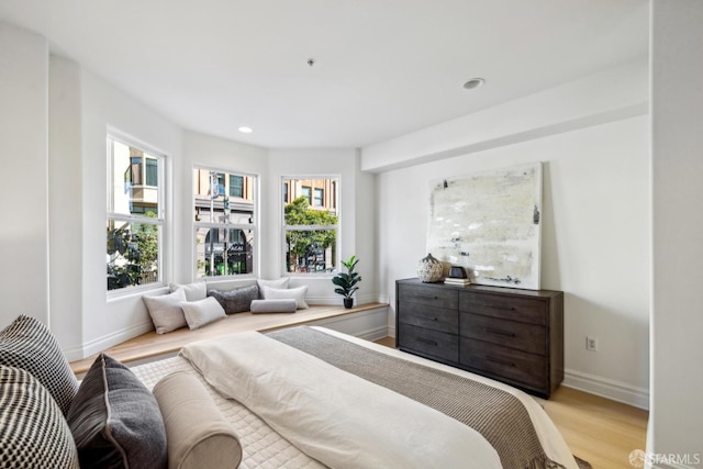 bedroom with recessed lighting, light wood-style flooring, and baseboards