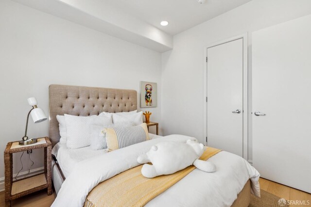 bedroom with recessed lighting and wood finished floors