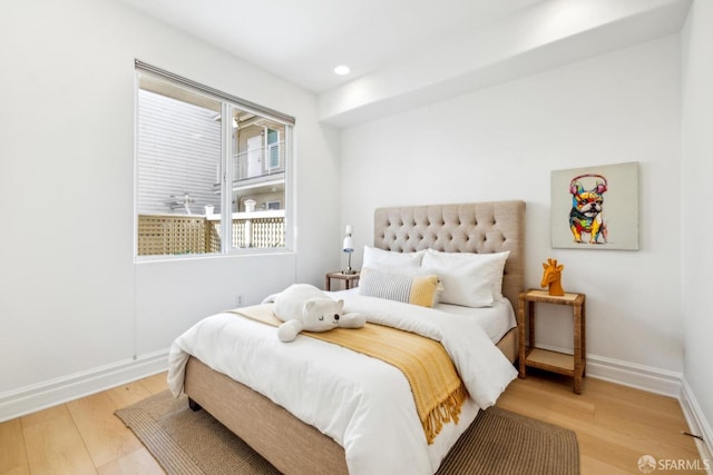 bedroom featuring light wood-type flooring, baseboards, and recessed lighting