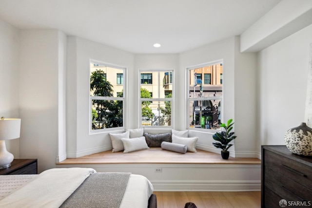 bedroom with recessed lighting, wood finished floors, and baseboards