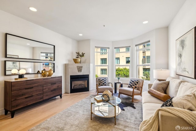 living area featuring recessed lighting, a wealth of natural light, and light wood-style floors