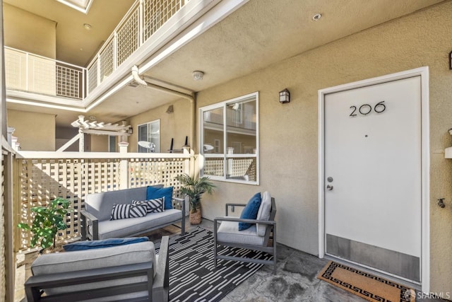 doorway to property with outdoor lounge area and stucco siding