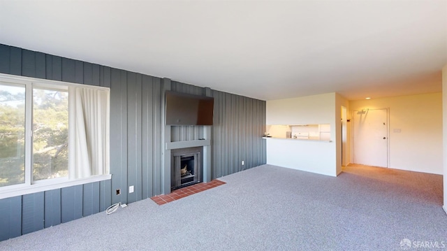 living room with carpet floors and plenty of natural light