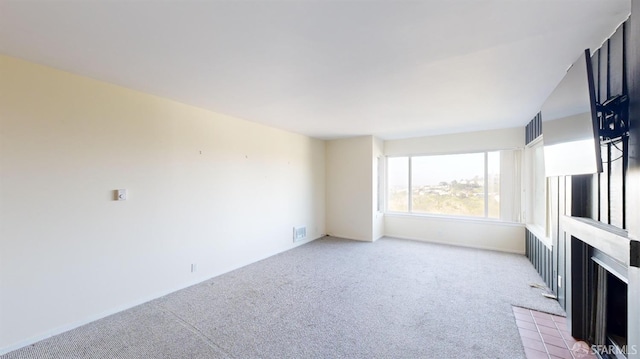 unfurnished living room with light colored carpet