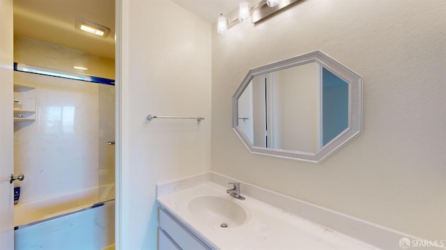 bathroom with enclosed tub / shower combo and vanity