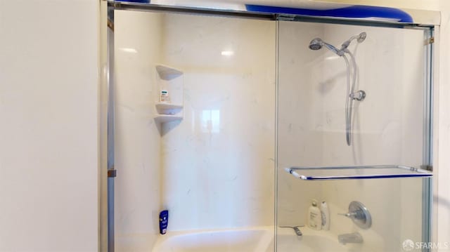 bathroom featuring shower / bath combination with glass door