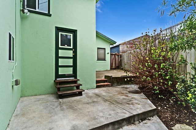 view of patio with entry steps and a fenced backyard