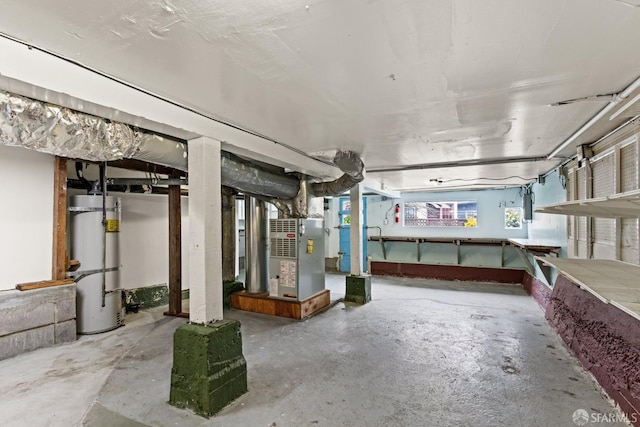 basement featuring heating unit and water heater