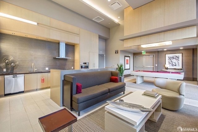 interior space with sink, pool table, and a towering ceiling