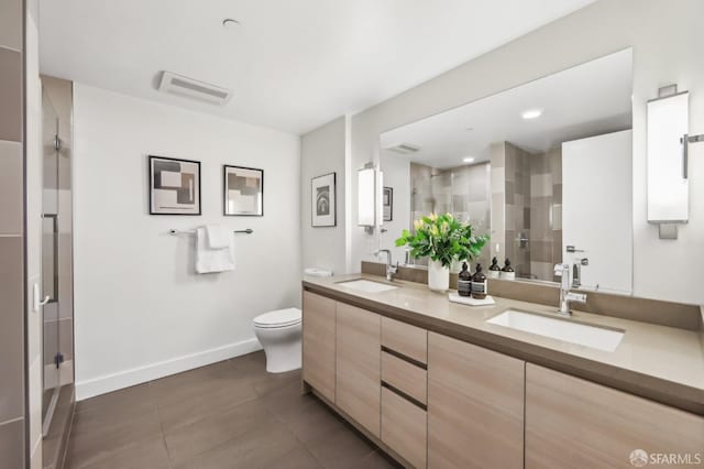 bathroom with an enclosed shower, vanity, tile patterned flooring, and toilet