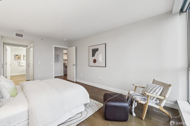 bedroom featuring hardwood / wood-style floors and ensuite bath