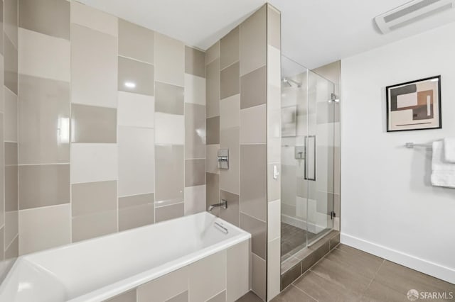 bathroom featuring shower with separate bathtub and tile patterned floors