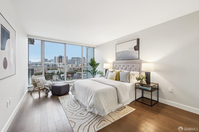 bedroom with dark wood-type flooring