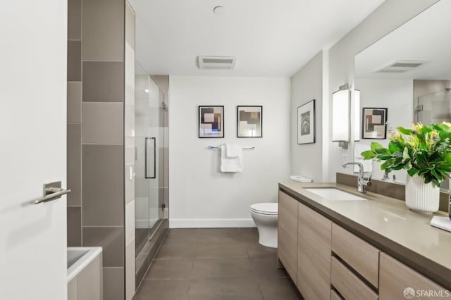 bathroom with toilet, vanity, tile patterned flooring, and a shower with shower door