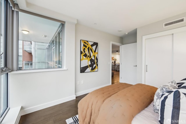 bedroom featuring dark hardwood / wood-style flooring and a closet