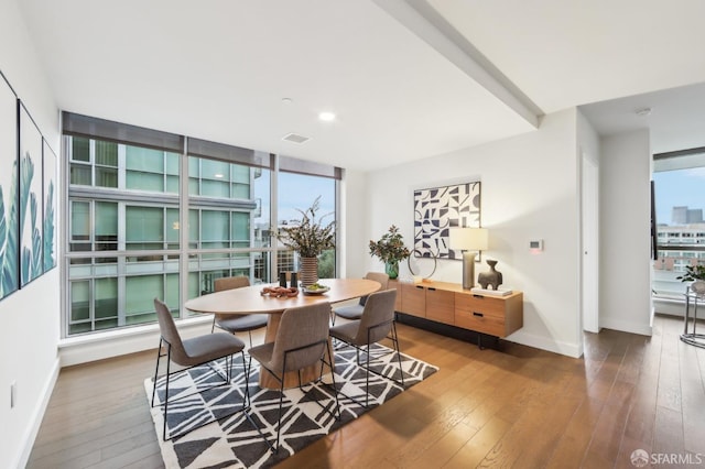 dining space featuring hardwood / wood-style flooring and a wall of windows