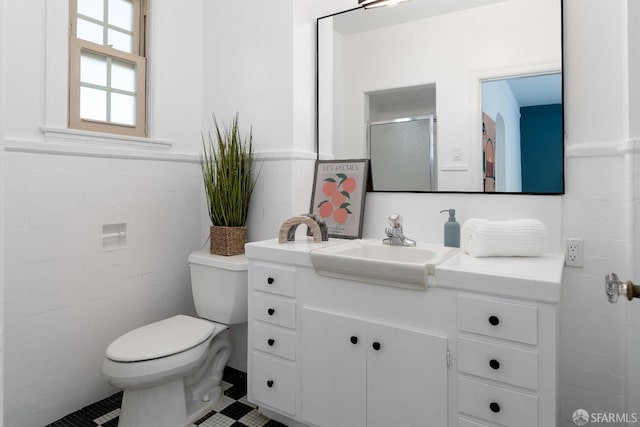 651 29th Ave, San Francisco, CA 94121 - bathroom featuring toilet, vanity, wainscoting, tile patterned flooring, and an enclosed shower