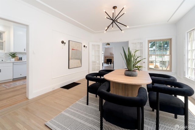 651 29th Ave, San Francisco, CA 94121 - dining area featuring a chandelier, light wood finished floors, and a fireplace