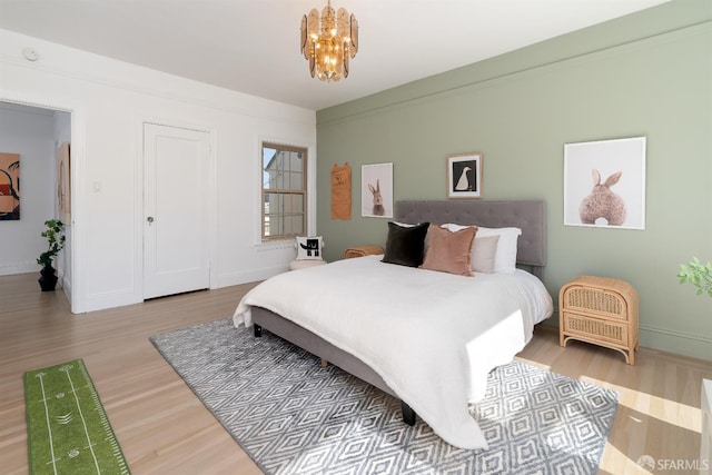 651 29th Ave, San Francisco, CA 94121 - bedroom with wood finished floors, a chandelier, and baseboards