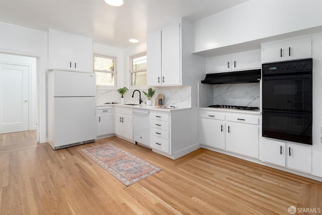 651 29th Ave, San Francisco, CA 94121 - kitchen featuring white appliances, under cabinet range hood, light countertops, light wood finished floors, and decorative backsplash