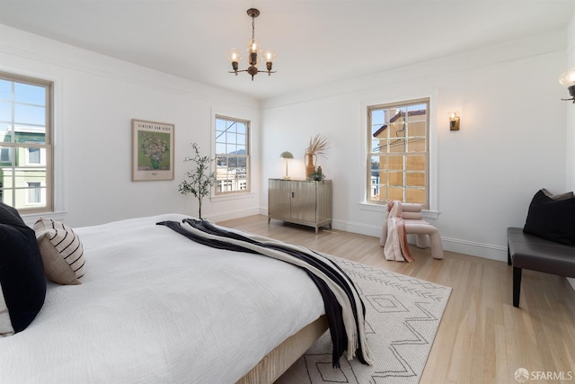 651 29th Ave, San Francisco, CA 94121 - bedroom with a chandelier, light wood finished floors, and baseboards
