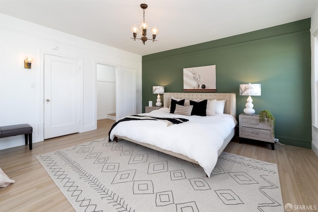 651 29th Ave, San Francisco, CA 94121 - bedroom with a chandelier, light wood-style floors, and baseboards