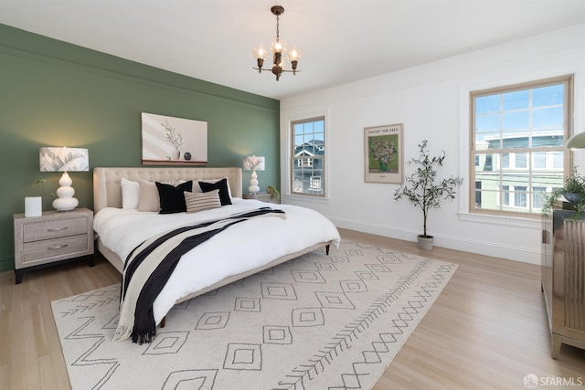651 29th Ave, San Francisco, CA 94121 - bedroom featuring wood finished floors, a chandelier, and baseboards