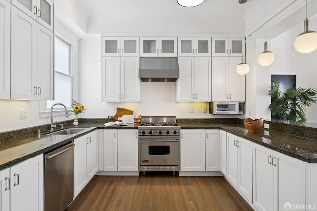 2427 Franklin St, San Francisco, CA 94123 - kitchen featuring stainless steel appliances, range hood, white cabinetry, dark wood-type flooring, and dark stone counters