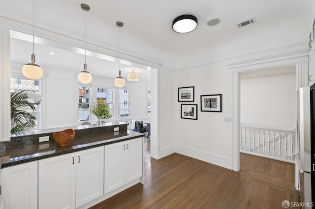 2427 Franklin St, San Francisco, CA 94123 - kitchen with dark wood-style floors, hanging light fixtures, white cabinets, and dark stone counters
